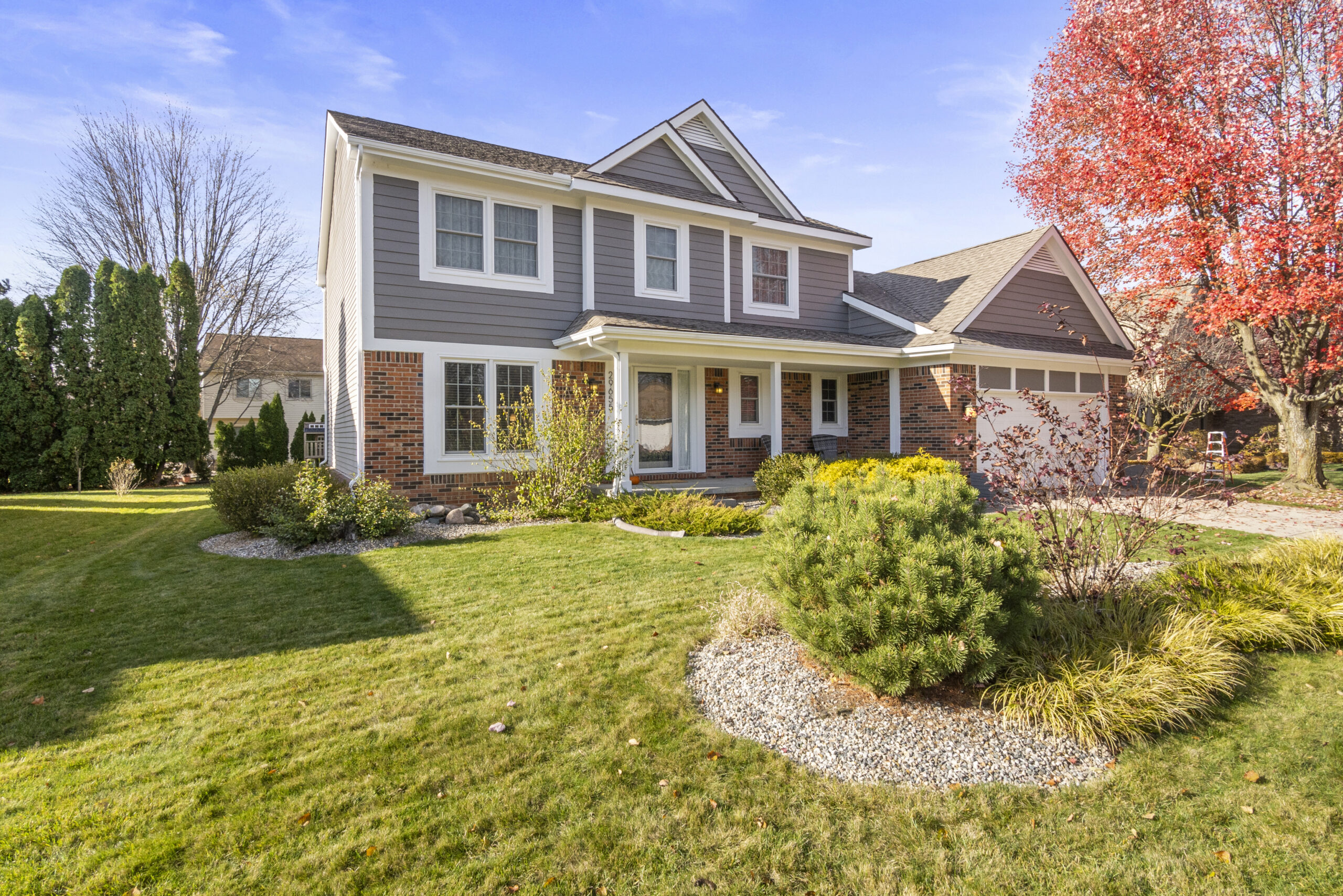 Luxury home in Novi, Michigan with landscaped yard and upscale suburban neighborhood setting.