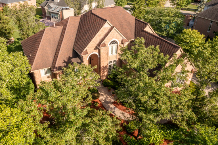 Luxury estate home in Novi, Michigan, with landscaped grounds and an elegant exterior.