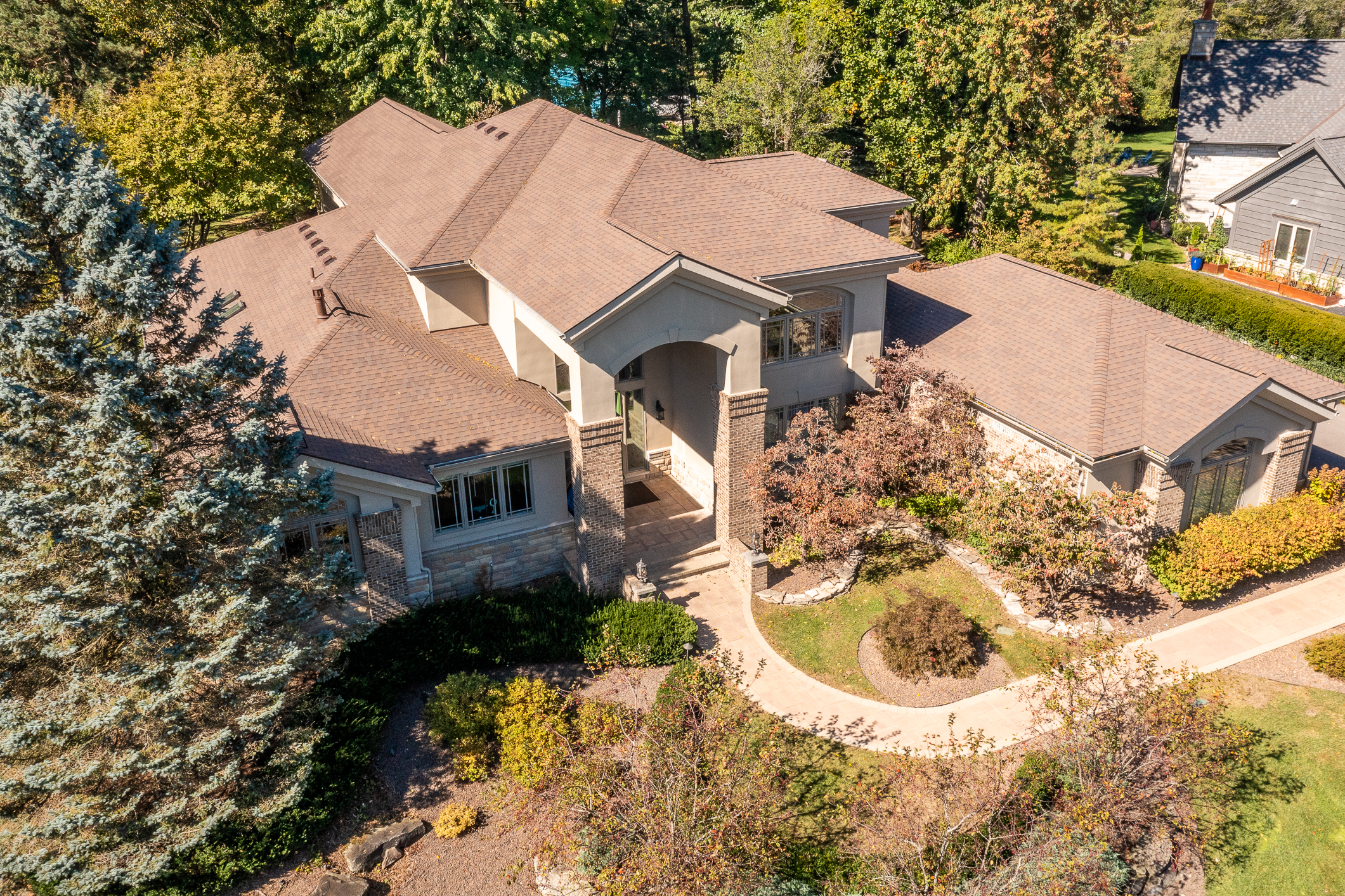 Aerial view of large residential home in Plymouth MI surrounded by mature trees